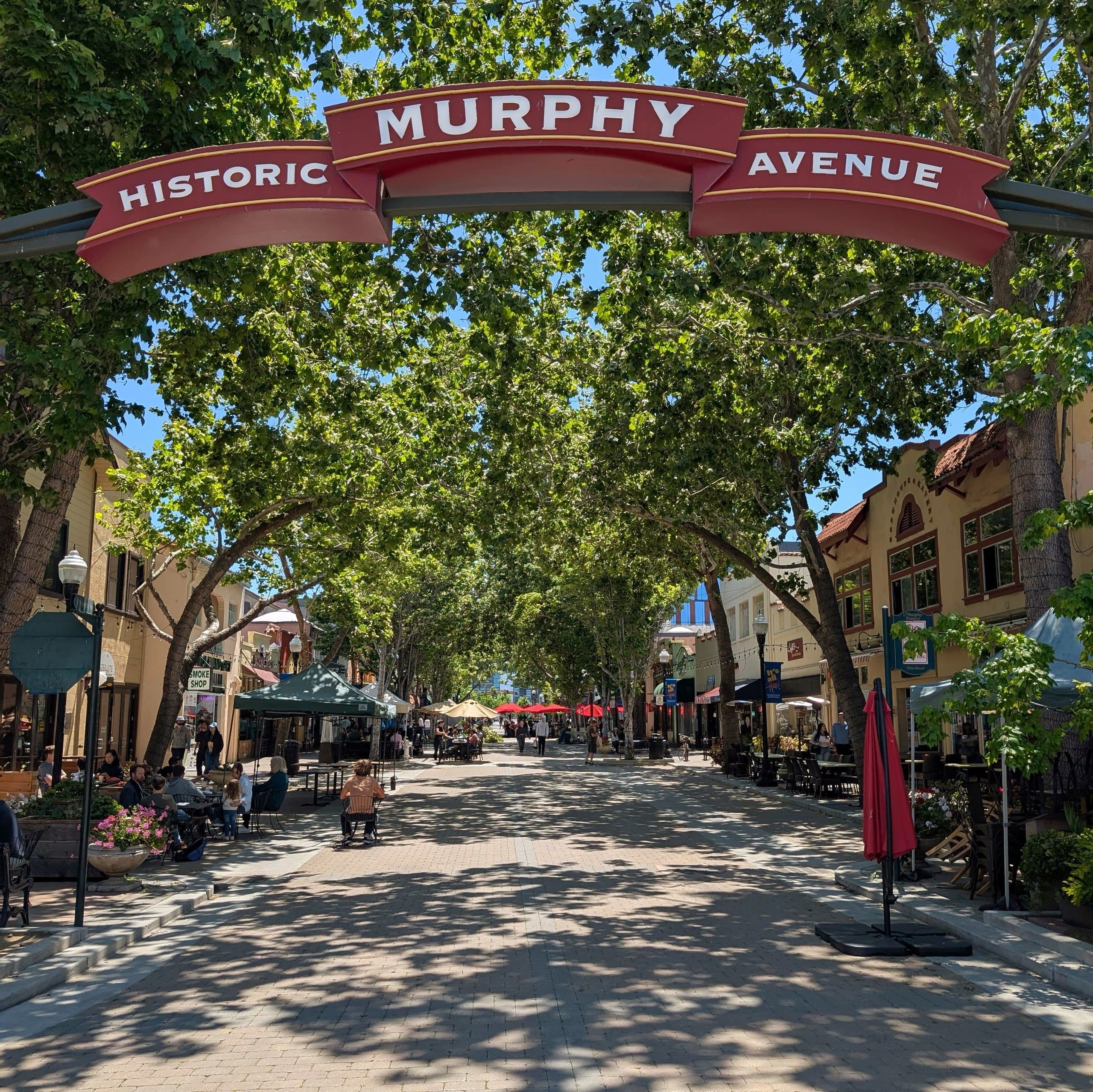 The Historic Murphy Avenue arch over a tree-shaded street of shops and cafés in downtown Sunnyvale
