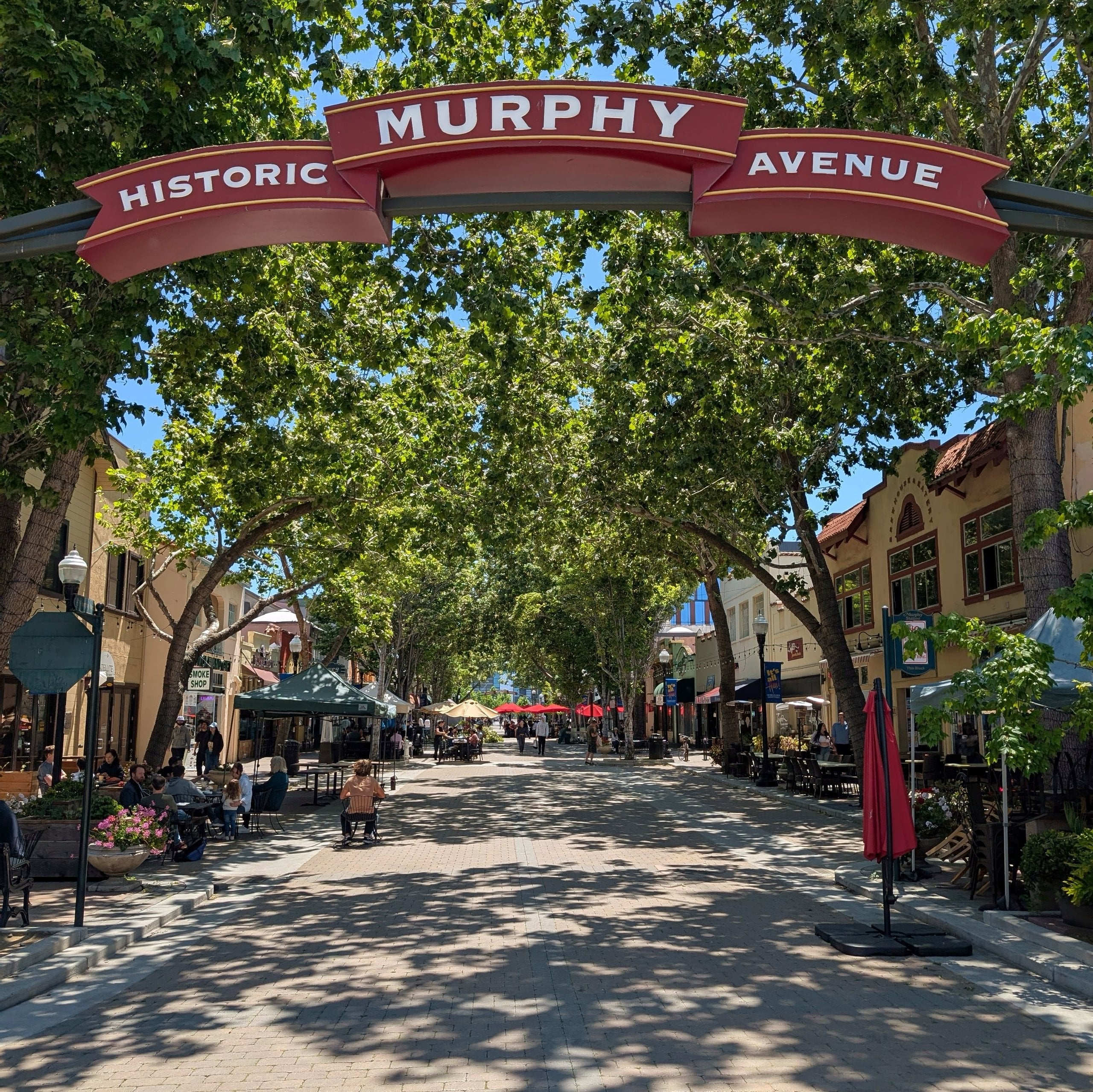 The Historic Murphy Avenue arch over a tree-shaded street of shops and cafés in downtown Sunnyvale