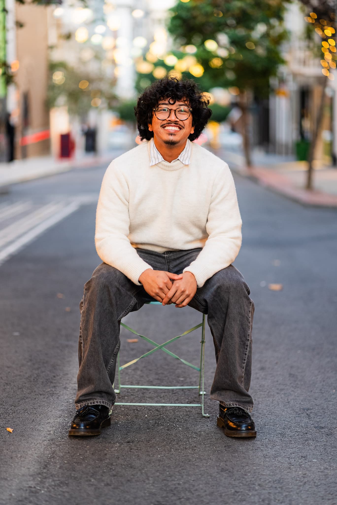 Jacob Ho, seated on a city street
